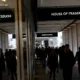 People walking near House of Fraser store entrance.