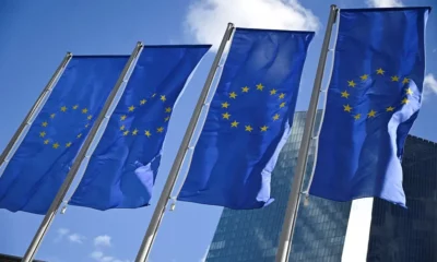 European Union flags against a blue sky.