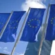 European Union flags against a blue sky.