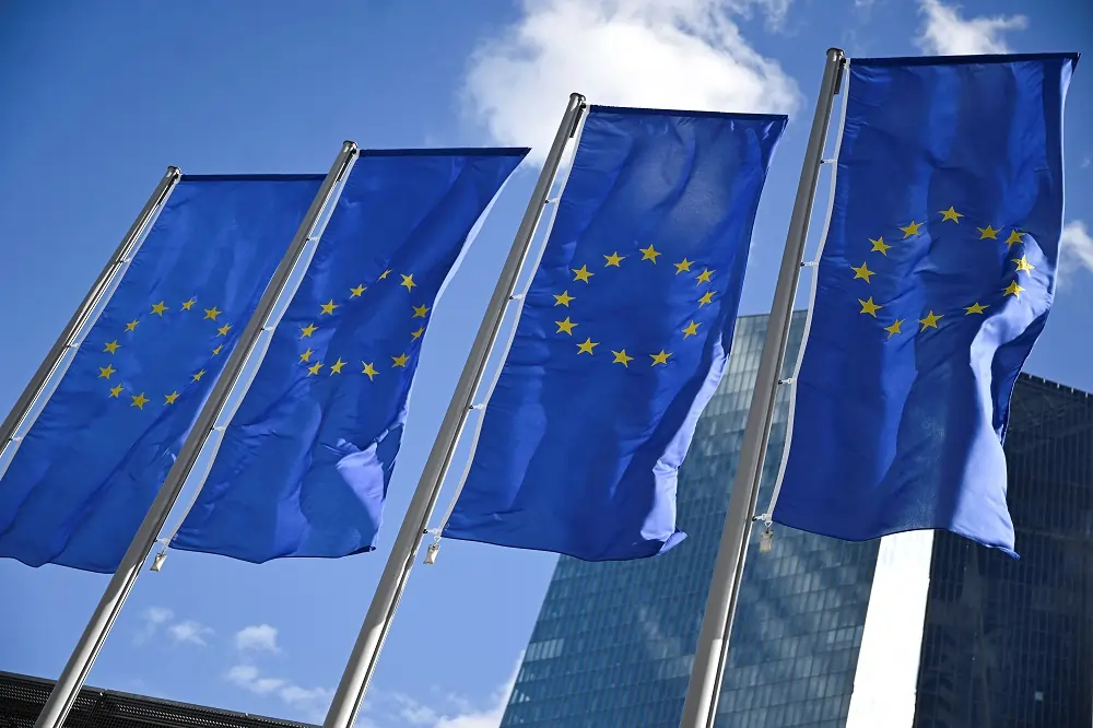 European Union flags against a blue sky.