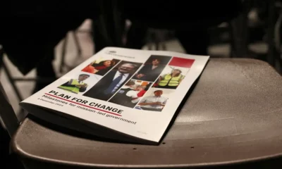 Booklet titled 'Plan for Change' on chair.