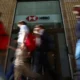 People walking past HSBC bank entrance.