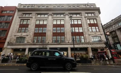 Marks & Spencer store with black taxi outside