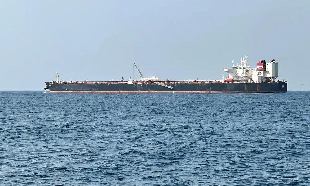 Large tanker ship on open sea horizon.