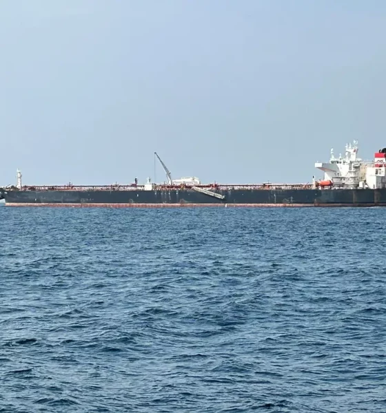 Large tanker ship on open sea horizon.