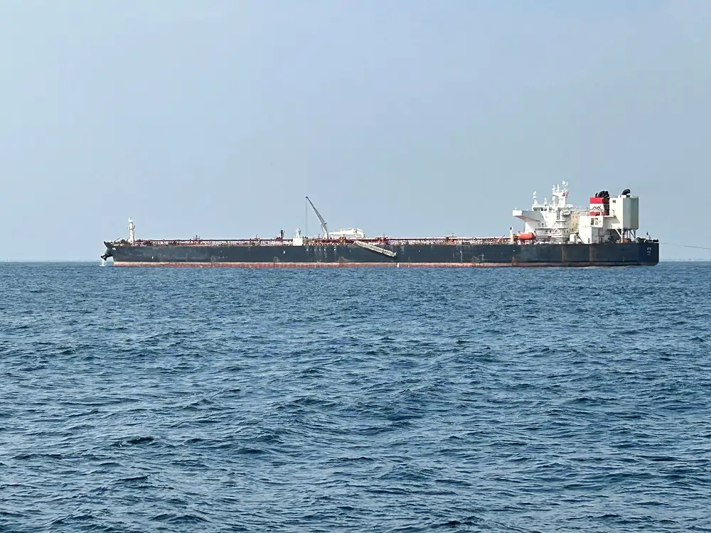 Large tanker ship on open sea horizon.