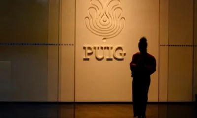 Silhouette in front of Puig company logo.