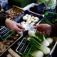 Exchanging money at a vegetable market stall.