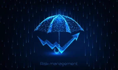 Digital umbrella with rising graph, representing risk management.