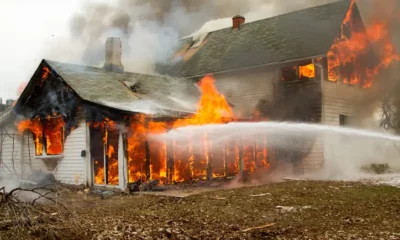 Firefighters extinguish blaze at burning house.