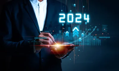 Person using tablet with futuristic 2024 graphics.