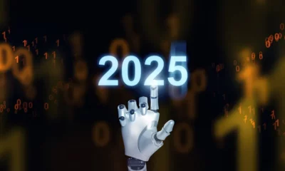 Robot hand touches glowing 2025 futuristic numbers.