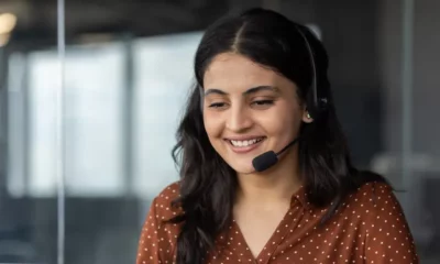 Woman smiling with headset in office environment