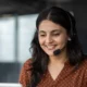 Woman smiling with headset in office environment