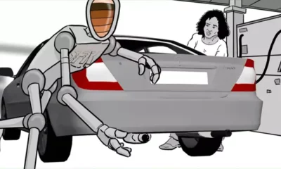 Robot checks car exhaust for emissions compliance.